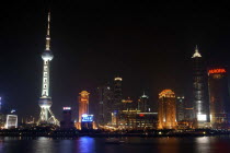 Waterfront city skyline and TV tower illuminated at night