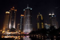 Waterfront city skyline with skyscrapers illuminated at night