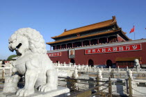 Tiananmen Monument aka Gate of Heavenly Peace with portrait of Mao on the front and stone lion statue in the foreground