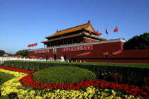 Tiananmen Monument aka Gate of Heavenly Peace with portrait of Mao on the front and flower beds in the foreground