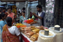 Brightly coloured food stall outside an Indian Temple