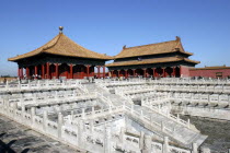 Small group of buildings in the complex on a raised level with steps leading up to them