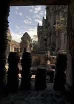 View through archway over pink sandstone ruins of Banteay Srei or The Citadel of the Women