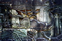 The Bayon. Carved detail of the pyramid temple built in the centre of the ancient city of Angkor Thom depicting figure with spear riding an elephant