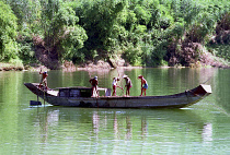 Fishermen on boat spearing for shell fish