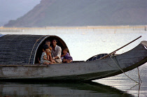 Father with three children on their house boat on the Lagoon