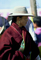 Lady watching festival wearing a hat