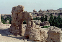 View over the Ancient ruins in desert landscape toward distant buildings