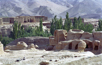 View over the Ancient ruins in desert landscape toward distant buildings