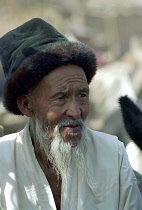 Portrait of an elderly man with a white beard wearing a fur rimmed hat