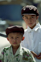 Portrait of two yound boys wearing caps