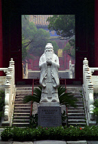 Temple of Confucius statue on engraved plinth at the bottom of some steps