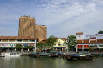 Junks on Singapore River with city architecture on the opposite bank