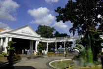 Green dragon statue and white entrance gate