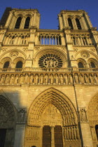 Angled view looking up at the west facade of the Notre Dame cathedral