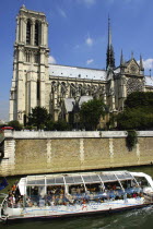 Glass topped tourist boat passing the Notre Dame Cathedral