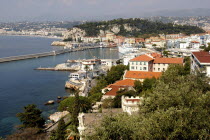 View over rooftops and harbour with the coastline beyond