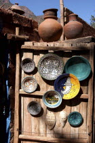 Display of ceramic plates and vases on a wooden cabin door