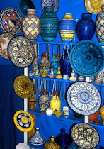 Display of brightly coloured ceramic vases and plates