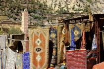 Carpet shop with rugs for sale hanging outside a shop