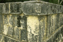 Corner detail of Mayan carved stone showing skulls