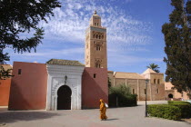 Koutoubia Mosque with entrance gate and tower and passing woman