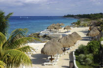 View over sandy beach with thatched umbrellas