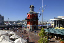 View over busy waterfront area toward the brightly coloured clock tower