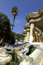 Gaudi dragon covered in brightly coloured tiles on the steps in Parc Guell