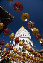 Ban Po  the Pagoda of a Thousand Buddhas seen between strings of red and yellow coloured Chinese New Year lanterns.