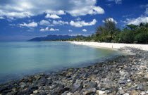 Pantai Cenang beach looking towards Gunung Mat Cincang with a stoney beach in the foregroundAsian Beaches Malaysian Resort Sand Sandy Seaside Shore Southeast Asia Tourism Holidaymakers Scenic Souther...