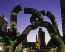 Tauentzien Strasse Kaiser Wilhelm Church at night viewed through a modern sculpture