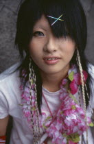 Harajuku District. Portrait of a teenage girl wearing a flower garland and sparkling hairclips