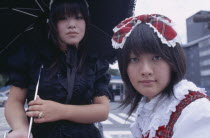 Harajuku District. Portrait of two young teenage girls with one wearing black and the other wearing tartan