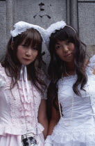 Harajuku District. Portrait of two young teenage girls wearing pink and white dresses