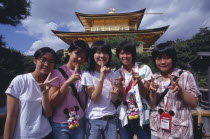 Group of teenage girls standing in front of the Kinkaku Ji aka Golden PavilionAsia Asian Japanese Kids Nihon Nippon Religion Pavillion Religious