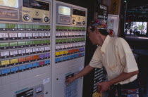 Shimbashi. Man using Restaurant Ticket vending machine