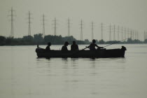 Silhouette of a two canoes with sports fishers on the Sulina arm of the Danube river