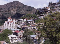 Church and village houses on hillside.