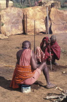 Maasai elders prepare the ground for a meat feast  which is part of the initiation ceremony that will bring the Maasai Moran into manhood.