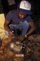 A mechanic repairs an electric motor