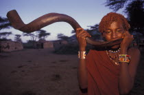 A Maasai Moran blows an Ikudu horn as part of innitiation ceremony bringing the young Maasai Moran into their manhood. On blowing this horn many of the Moran go into trance.