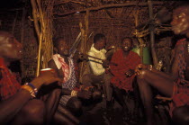 Maasai moran young warriors drinking milk during an initiation ceremony which brings them into manhood. The Maasai diet consists almost entirely of meat blood and milk.