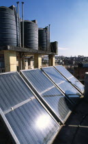 Nepal, Kathmandu, Locally produced solar water heaters on rooftops with black hot water reservoirs.  