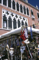 Street stall selling tourist masks with the Danieli Hotel behind