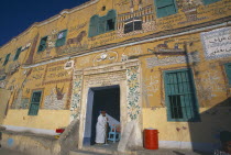 Detail of painted mural on exterior wall of alabaster shop.