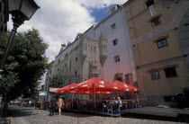 View of restaurant with red table umbrellers in Skadarlija Pedestrian area.