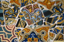 Parc Guell.  Detail of colourful mosaic by Gaudi from a park bench seat.