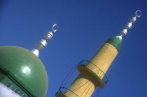 Elephantine Island. Minaret and dome of small mosque painted green and yellow against blue sky.