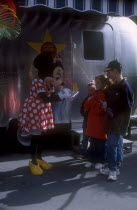 Walt Disney World. Minnie Mouse signing autographs for three children outside her star trailer. **Editorial Use Only**